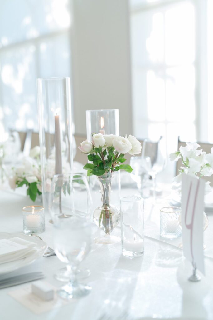 Candles and floral decoration at reception party tables.