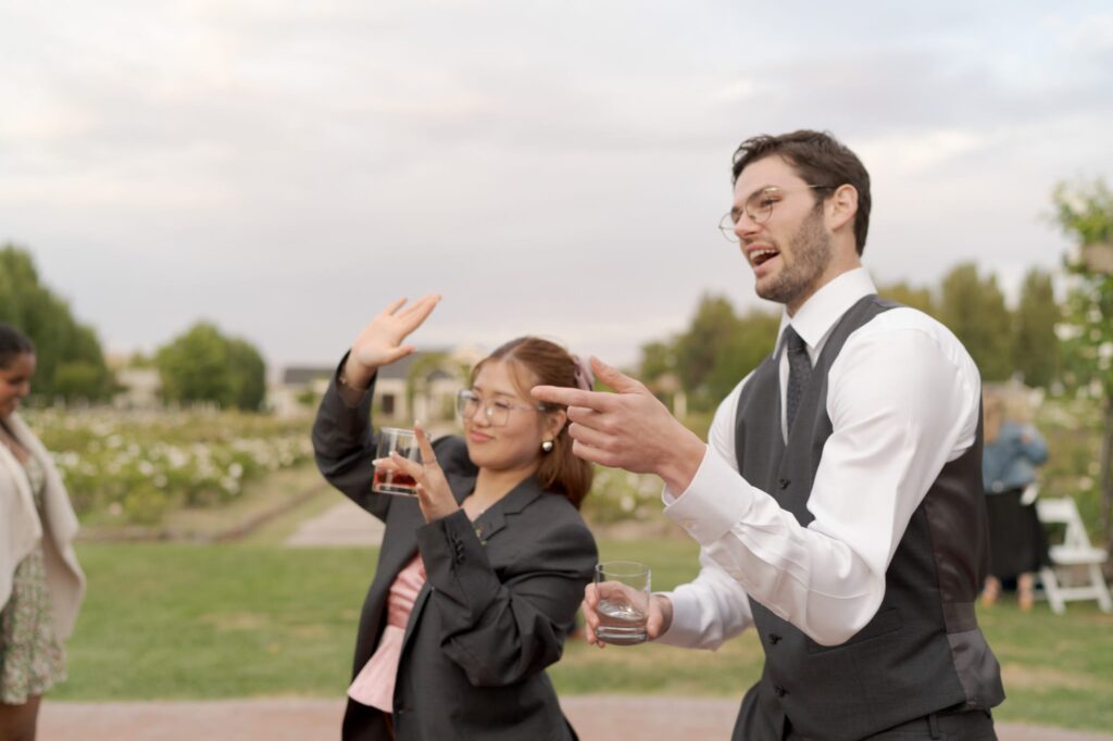 Wedding guests watch the newly married couple dance.