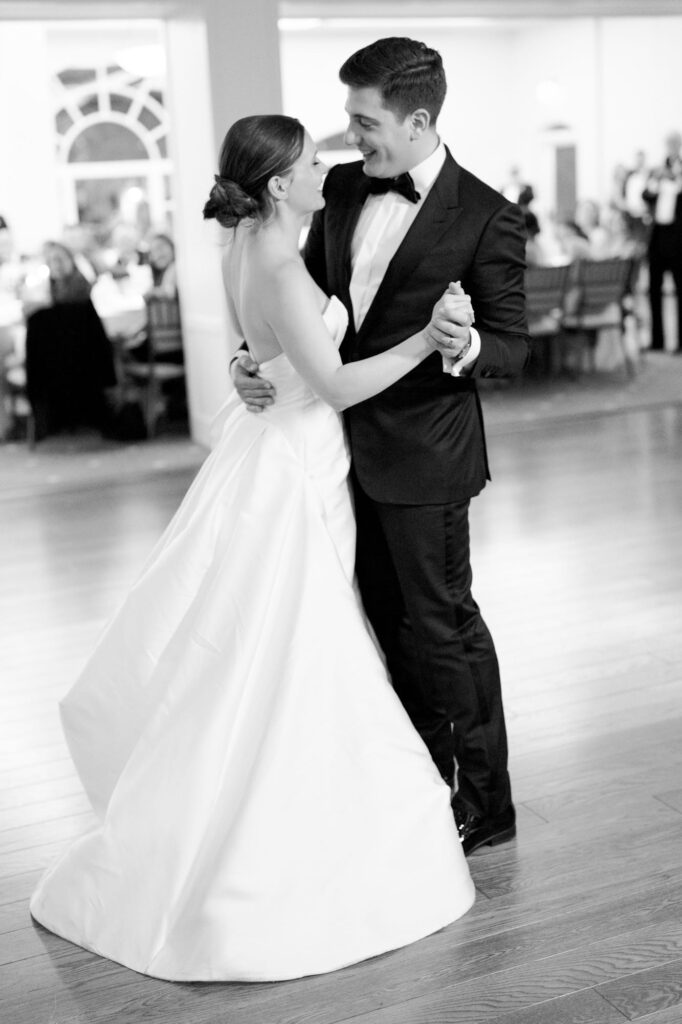 Newly pronounced husband and wife emrace each other and dance at their reception party in Menlo Circus Club.