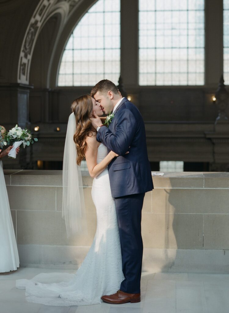 Newly pronounced husband and wife kiss after their wedding.