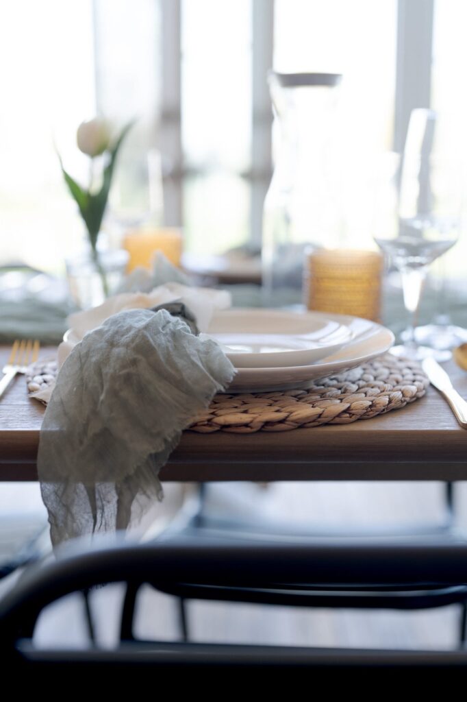 Plate rests on a hand-knitted placemat on a wooden table.